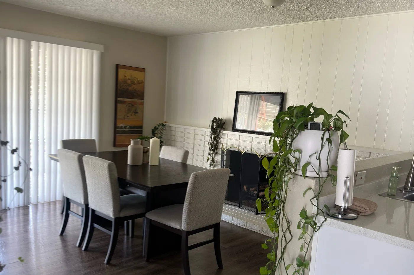 A dining room and kitchen in Corona after one of our cleans, with clear counters and swept floors